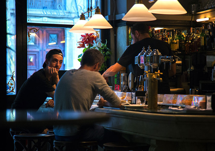 Hombres sentados en bar de tapas